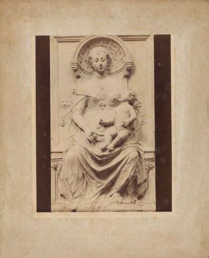 Relief of a woman with a baby on her lap, possibly depicting Mary with child
