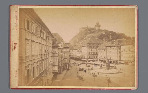 View of the Hauptplatz with the Archduke Johann Fountain and the Schlossberg in Graz, Austria