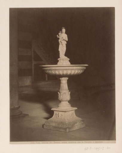 Baptismal font with sculpture of Mary with child in the Cathedral of Pisa, Italy