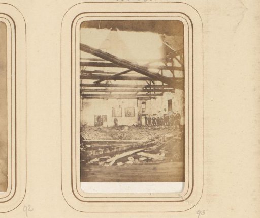 Men Viewing the Damage to a Building After a Fire