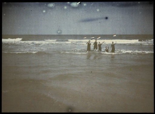 Jacob Olie, Tine, Fifi and two unknown persons standing in the sea