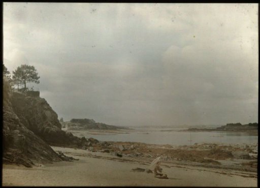 Tine sitting on a beach