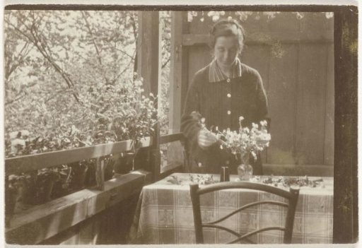 Portrait of Irene With with flowers at a table