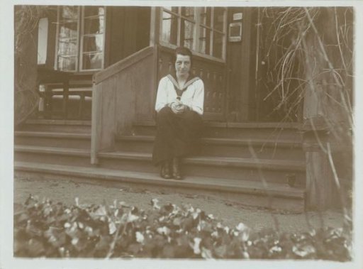 Portrait of Irene With, seated on stairs