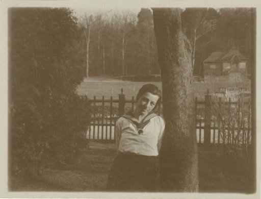Portrait of Irene With, leaning against a tree
