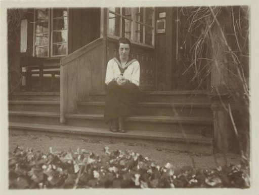 Portrait of Irene With, seated on stairs