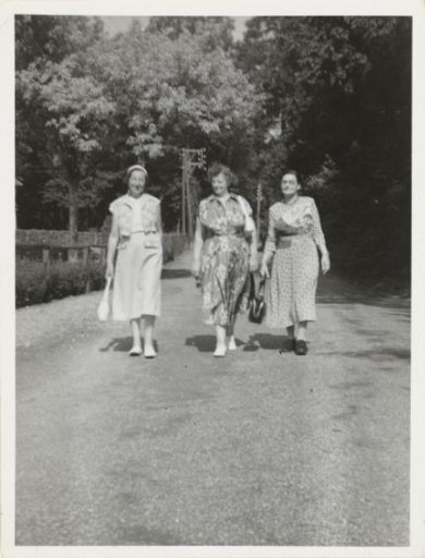 Portrait of Irene With and two unknown women walking in the street