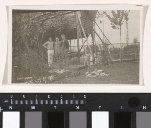 Karl With and two unknown men at a house on piles