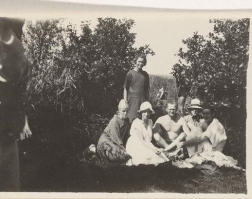 Group portrait of Karl With with seven unknown persons in the grass
