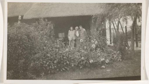Irene With with two unknown persons in a garden