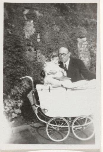 Unknown man with a child by a pram