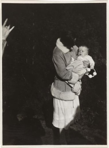Unknown woman with a child in her arms