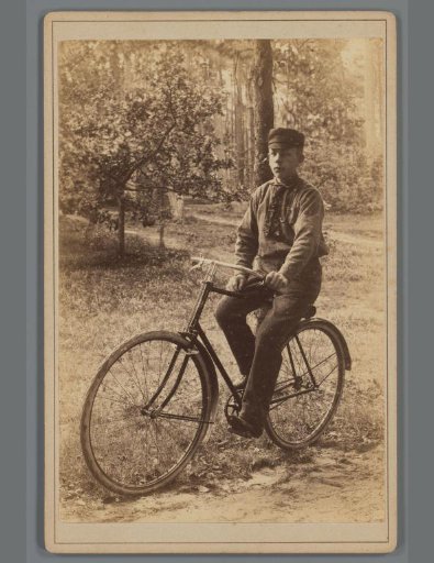 Portrait of Jacob Olie junior on a bicycle