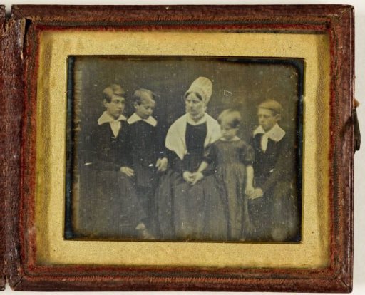 Group portrait of an unknown woman and four children
