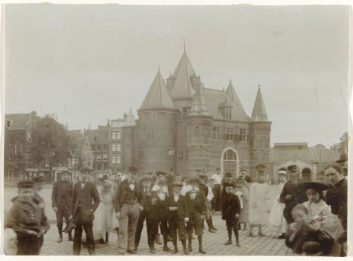 View of the Waag and the Nieuwmarkt in Amsterdam, with several spectators in the foreground