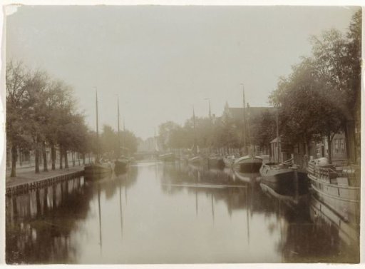 View over a canal with ships along the quay, probably in the Netherlands