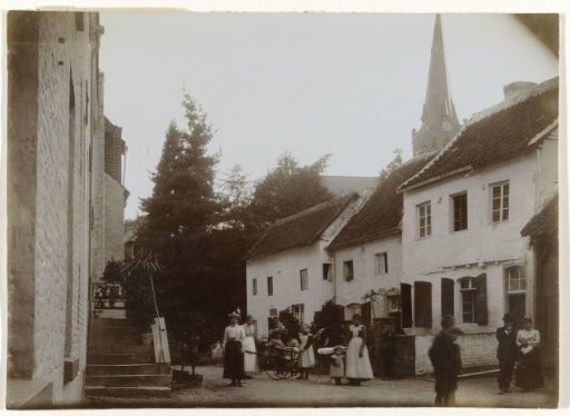 Street scene, probably in the Netherlands, with a church tower in the distance