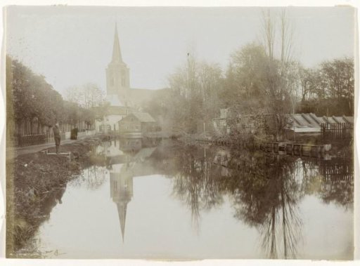 View of a wide ditch, with a church in the distance, probably in the Netherlands