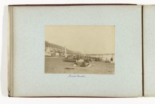View of the beach at Shanklin with pier and bathing guests, with possibly Henry Pauw van Wieldrecht lying in the foreground and looking at the camera