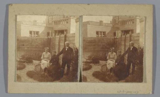 Two women and a man in a garden