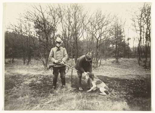 Gamekeeper and Assistant with a Dog Fetching a Rabbit