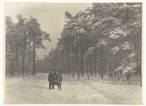 Man and Girl in the Snow on the Forest Avenue in the Park Berg en Bosch in Apeldoorn