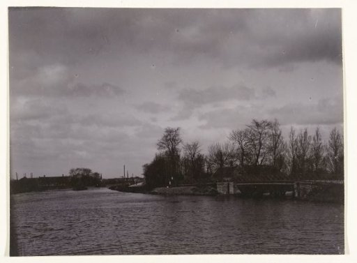 View of a Road Along the Water, a Bridge and Buildings