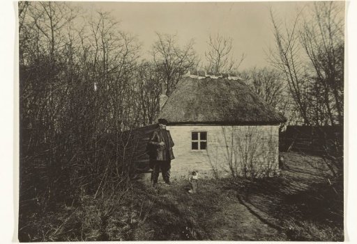 Man with a Dog in front of a House or Farm