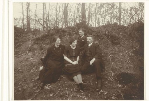 Two Men and Two Women Sitting Against a Slope
