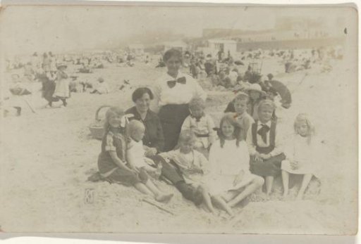 Portrait of an unknown group of people sitting on a beach