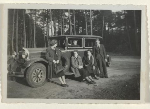 The Ochse family around a car in the woods