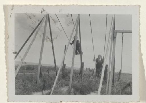 Two people swinging on the beach at Valkeveen