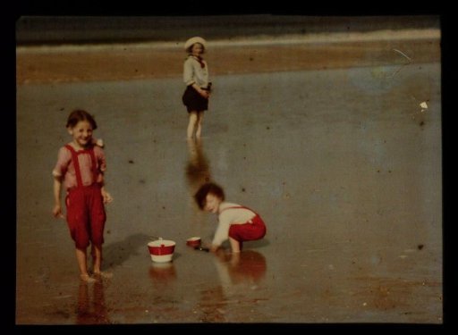 Three children playing on the North Sea beach