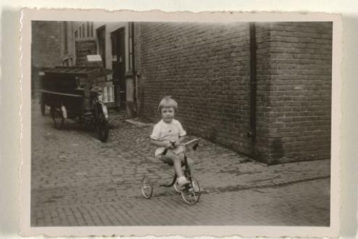 Girl on a tricycle on the street
