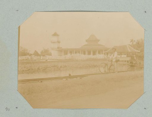 Man with a Bicycle Posing in Front of the Masjid Agung, the Great Mosque of Palembang