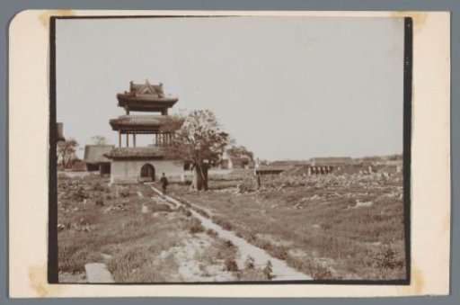 A building (a temple?) surrounded by a few dilapidated buildings, China?