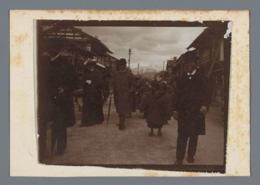 Walking people (the travel party of Adriani?) in a street, Japan