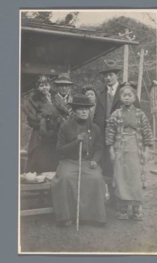 Portrait of two men, two women (of the traveling party), a Japanese girl and a Japanese woman in a simple tea house (?), Nikko, Japan