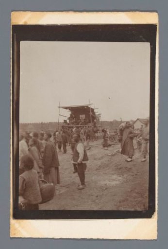 Spectators at a performance on a stage near a wall (the Great Wall?), China