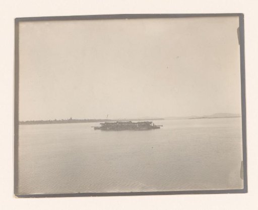 A wooden raft on the water with mountains in the distance, South-East Asia