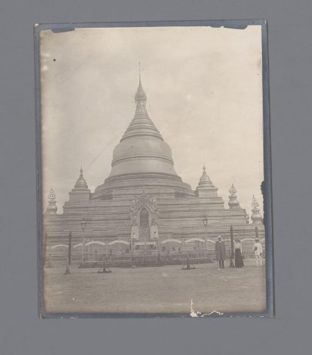 A man and a woman in front of a Buddhist shrine, Myanmar