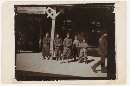 Portrait of a group of waiting men and boys, China