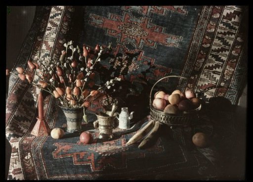 Still life of fruit and flowers on a carpet