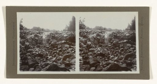 Two men above the rapids of the Banyupait river