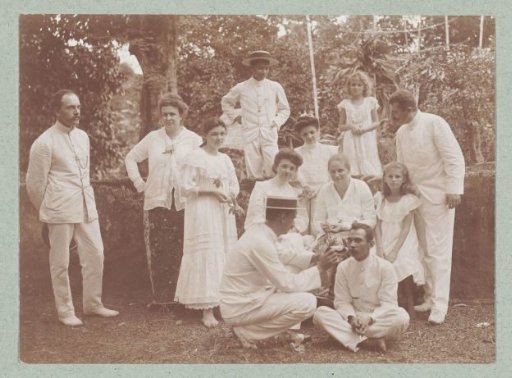 Group portrait of Europeans in the tropics, dressed in white.
