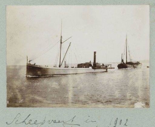 Barge and Single-Masted Vessel at Sea