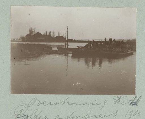 People on a boat with sandbags near the flooded village of Kethel after a dike breach