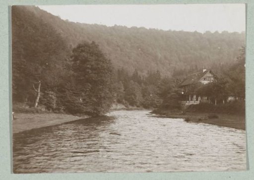 River flowing through the valley of a wooded mountain landscape