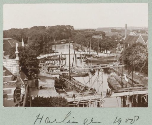 Canal view in Harlingen with several flat-bottomed sailing ships