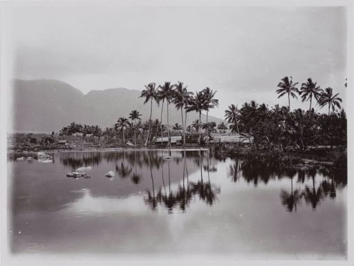 View of a Village from a Lake Against the Background of a Mountain Landscape